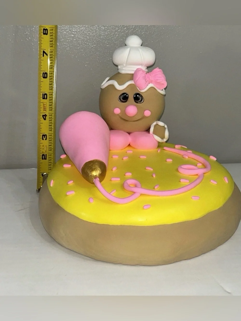 Whimsical Pink & Yellow Fake Gingerbread Baker on Giant Sugar Cookie Display
